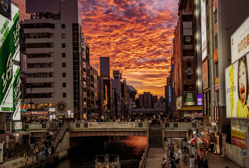 Busy Tokyo streets in the heat with tall buildings trapping hot air and creating an urban heat island.