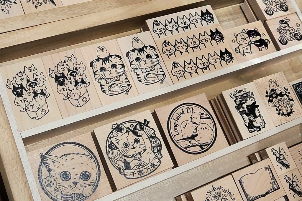 Display of wooden rubber stamps with cat and animal designs.