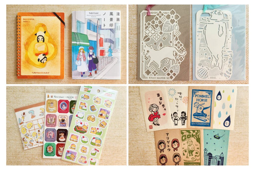 Flatlay of freebies and purchased items including notebooks, stickers, and bookmarks.