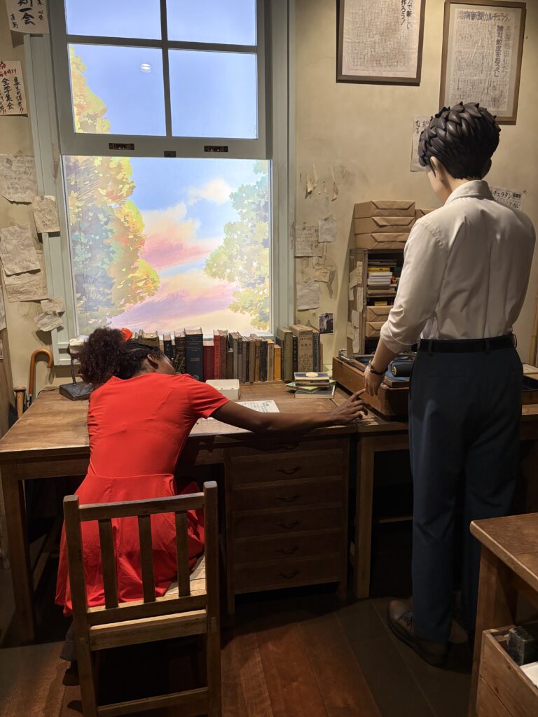 eplica study room scene with a male character figure at a desk, while a visitor in a red dress sits dramatically at the table.