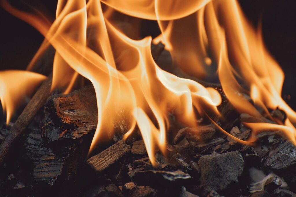 Close-up of glowing fire and charred wood.