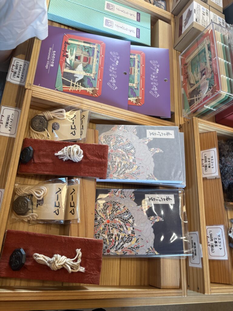 Studio Ghibli Park souvenir shop display featuring Mononoke Village-themed stationery and items.