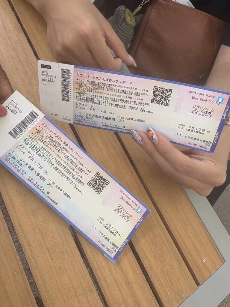 Two Studio Ghibli Park O-Sanpo Standard tickets held in hand with Ghibli nail art.