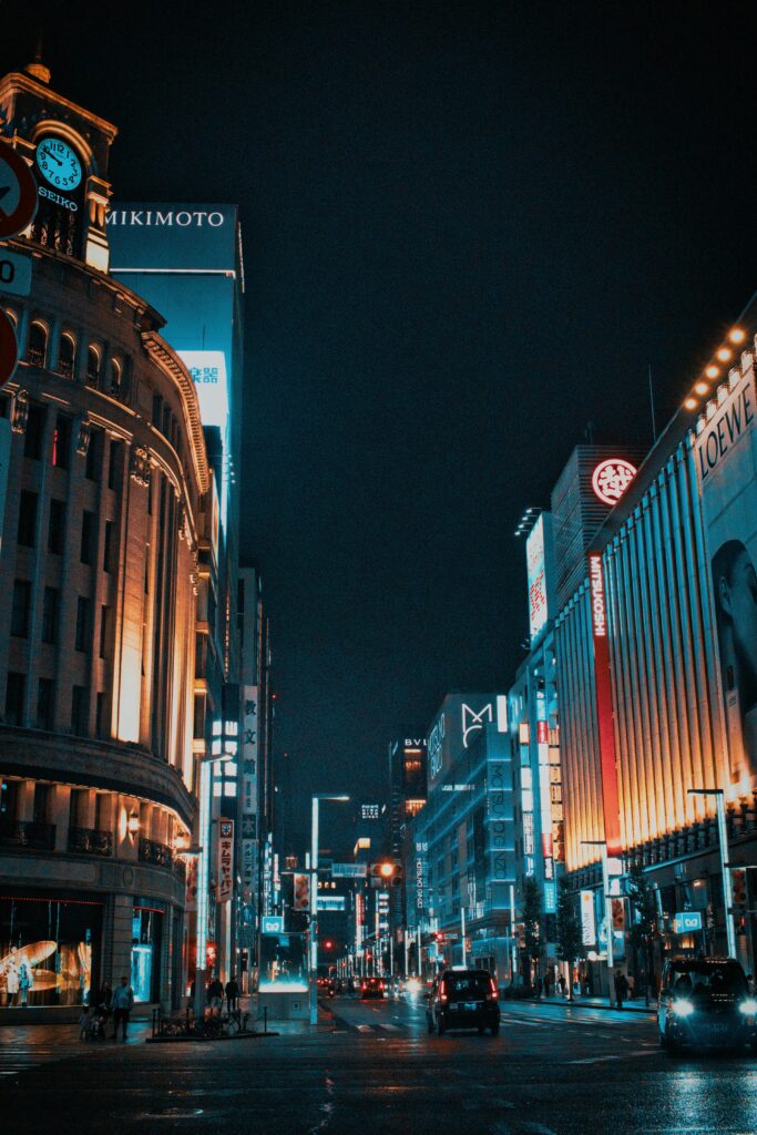 Wako Department Store clock tower illuminated at night in Ginza, Tokyo.