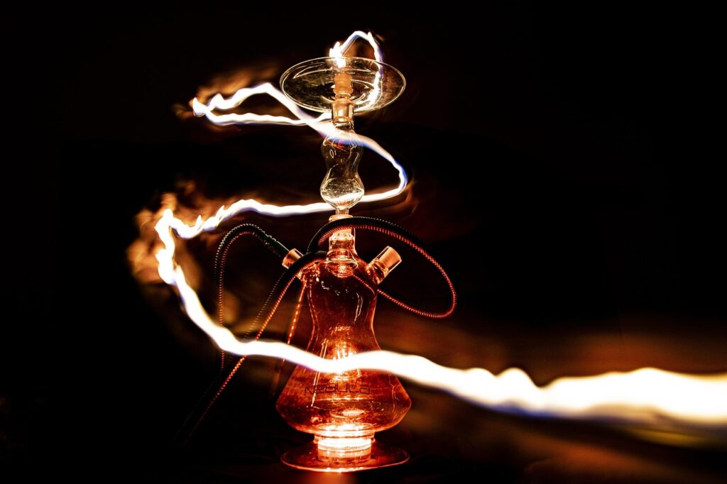 Glowing hookah with light trails in the dark.