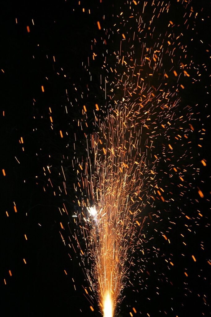 Sparks flying from charcoal during lighting.