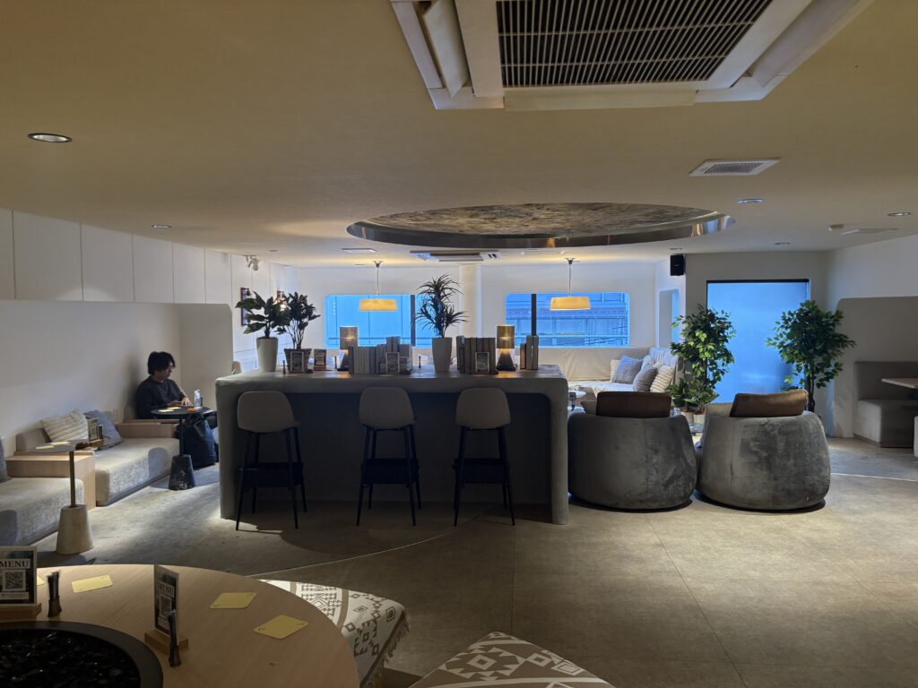 Spacious lounge interior with cozy seating and warm lighting.