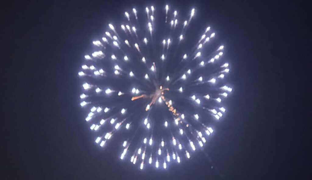 Single blue firework shining brightly in the night.