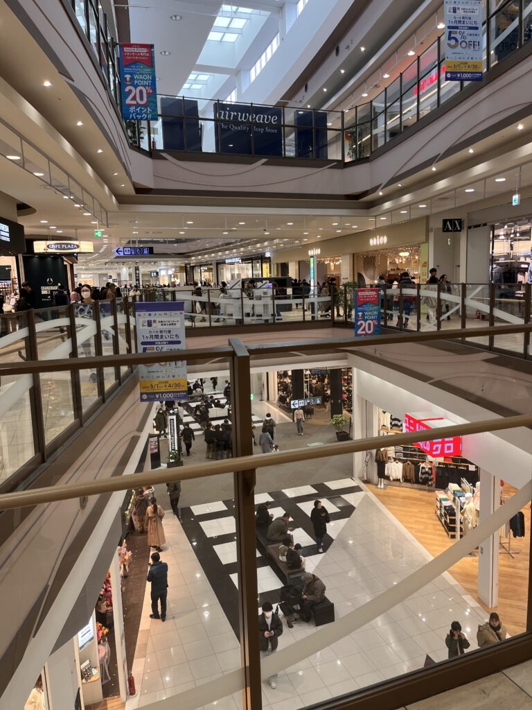Interior of Aeon Laketown Mori with multiple levels of fashion and lifestyle stores.
