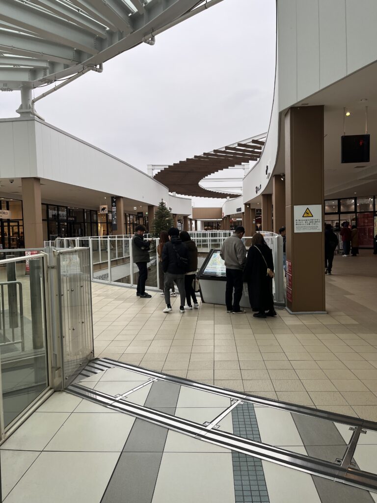 Open-air walkways and shopfronts inside the Laketown Outlet outdoor mall.