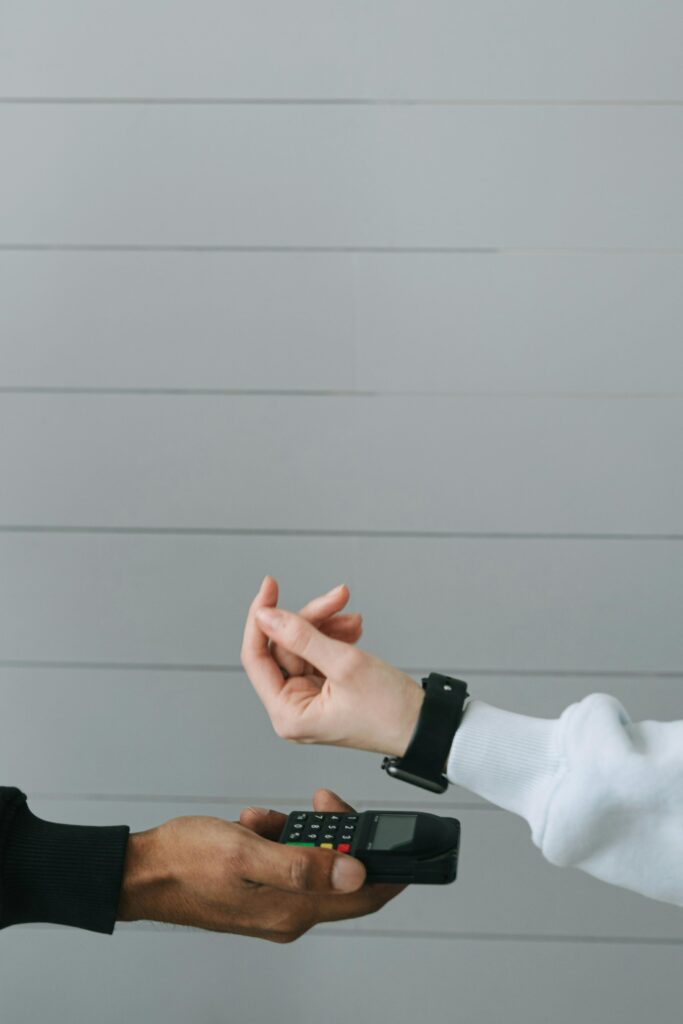 A customer paying with a smartwatch through a contactless terminal.