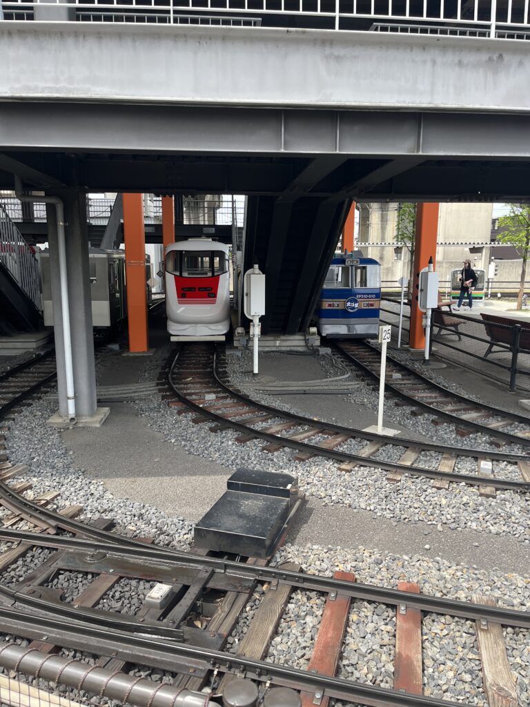 Small train car replicas on miniature tracks outside the museum, part of the kids’ railway where children can experience driving real mini-trains.