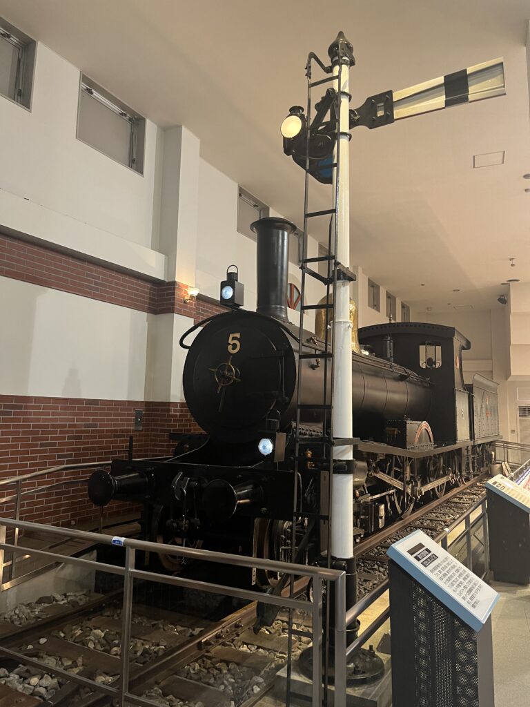 A vintage Tobu train displayed indoors, painted dark brown and representing one of the earliest private railway models in Japan.