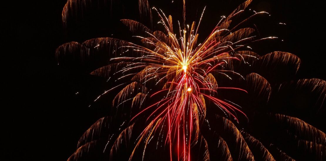 Red and gold fireworks bursting against a dark sky.