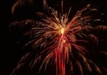 Red and gold fireworks bursting against a dark sky.