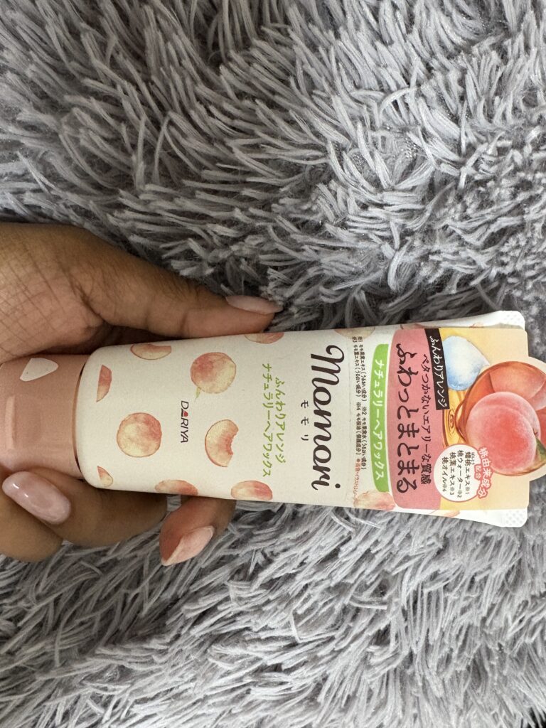 Fresh Japanese peach on a tree branch