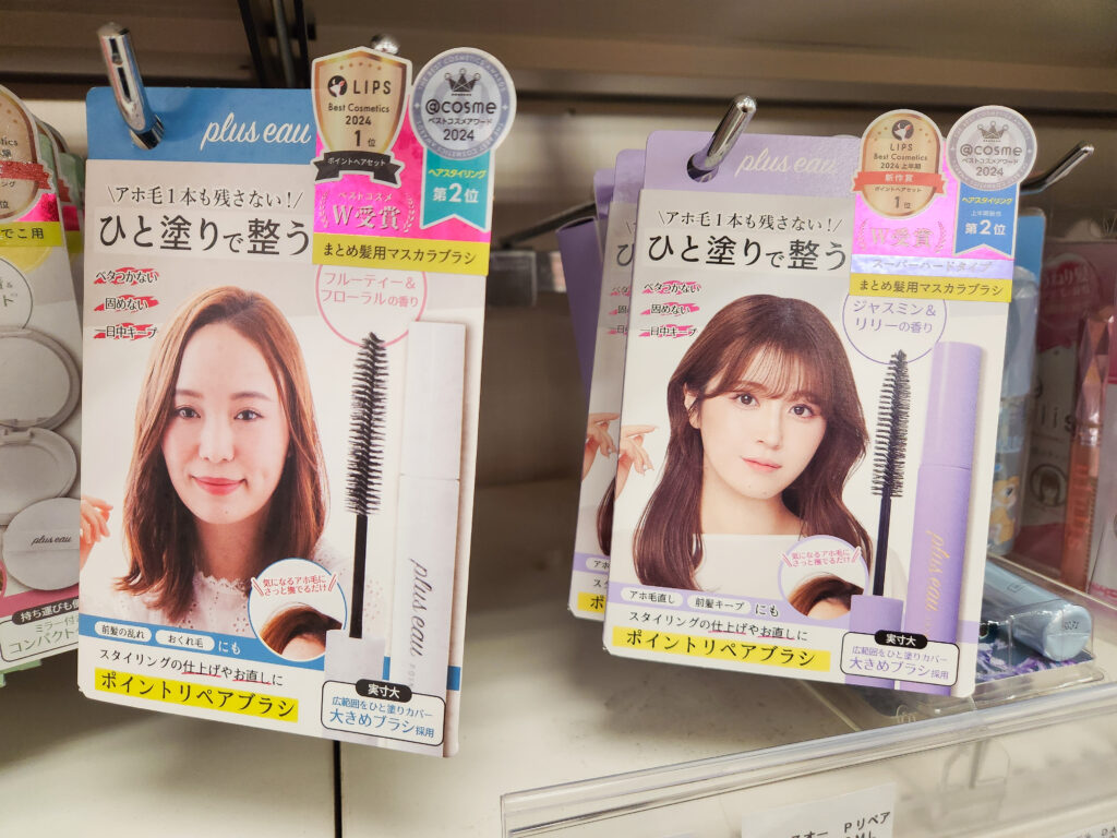 Utena Matomage Hair Styling Sticks in pink, teal, and purple packaging on a store shelf with price tags.