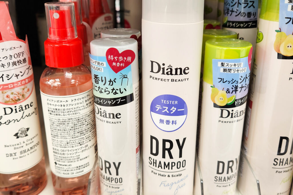 Diane Perfect Beauty Dry Shampoo bottles in various scents on a store shelf, including tester and fragrance-free variants.