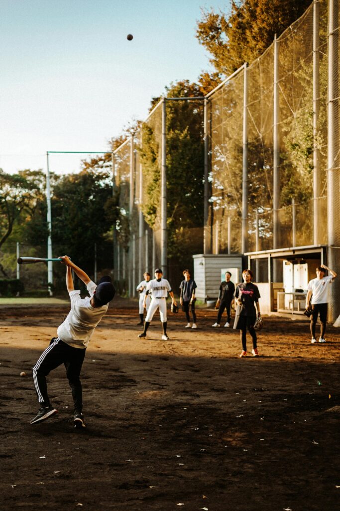 Japanese baseball players practicing on a dirt field, showcasing Japan’s love for the sport.