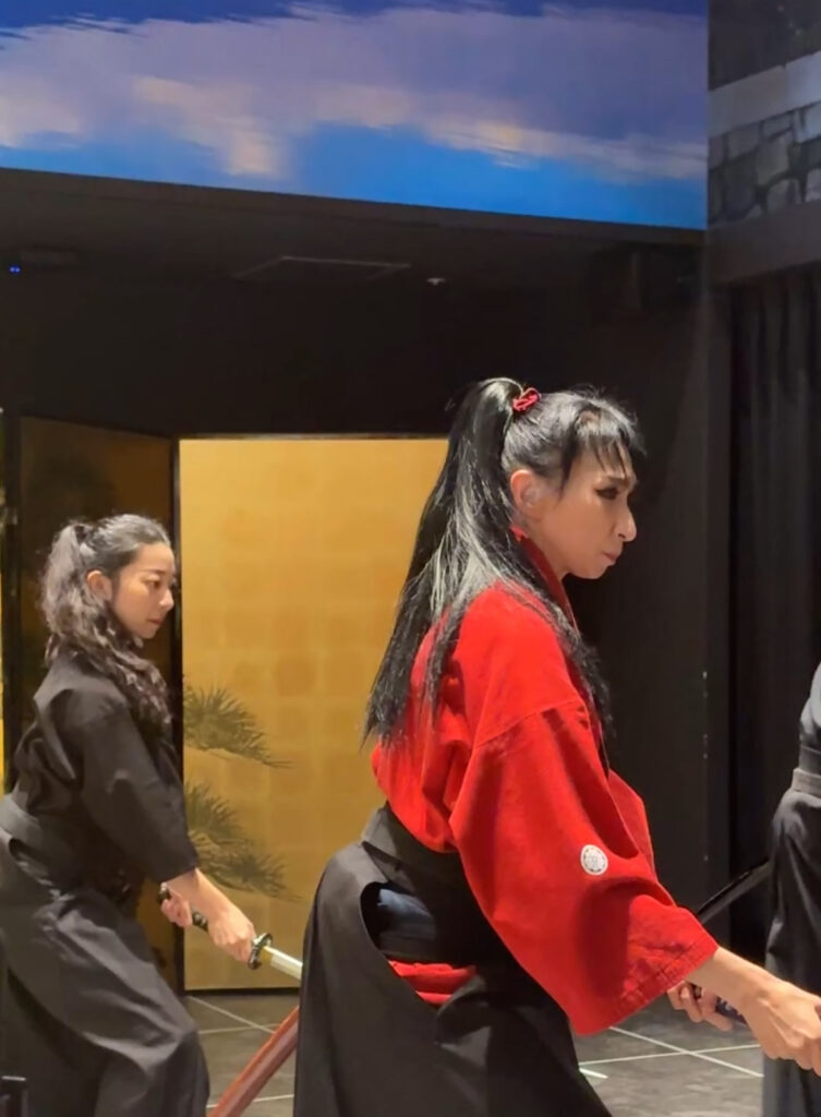 Performers demonstrating traditional samurai sword techniques during the samurai show at Michi.