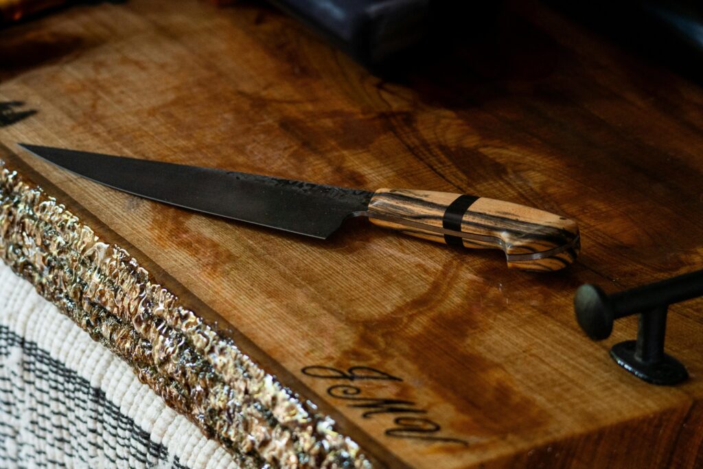 A handcrafted Japanese knife with a striped wooden handle