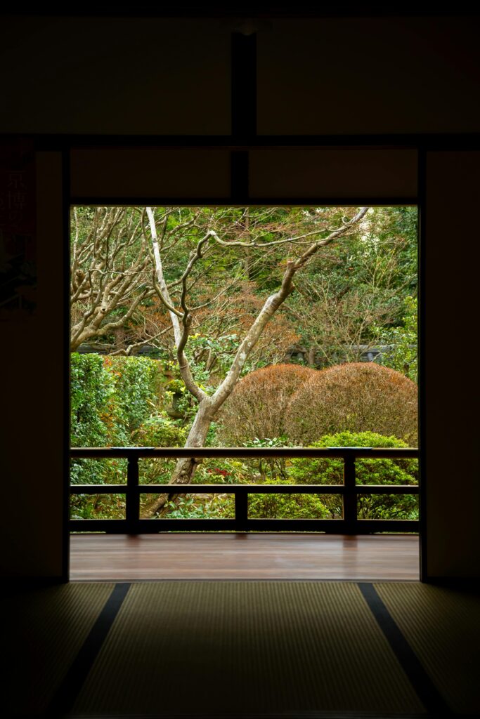 Japanese garden viewed through the open frame of a traditional room