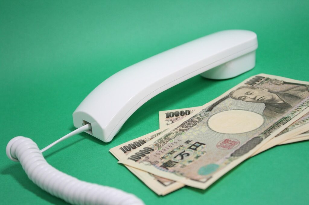 Japanese yen banknotes next to telephone handset