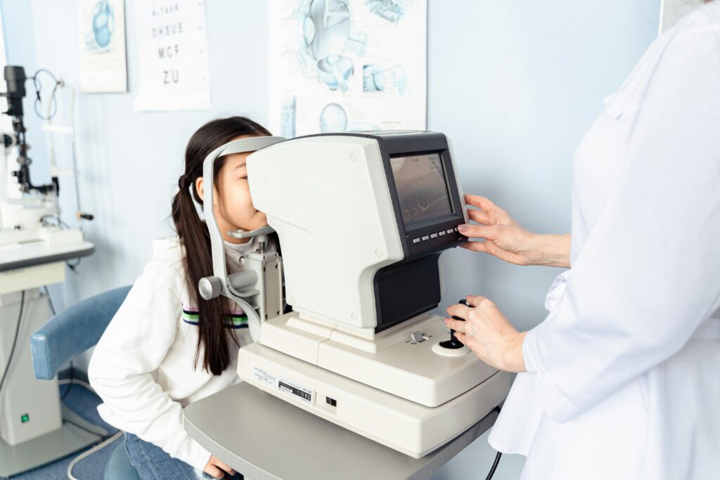 Child undergoing an eye examination using diagnostic equipment
