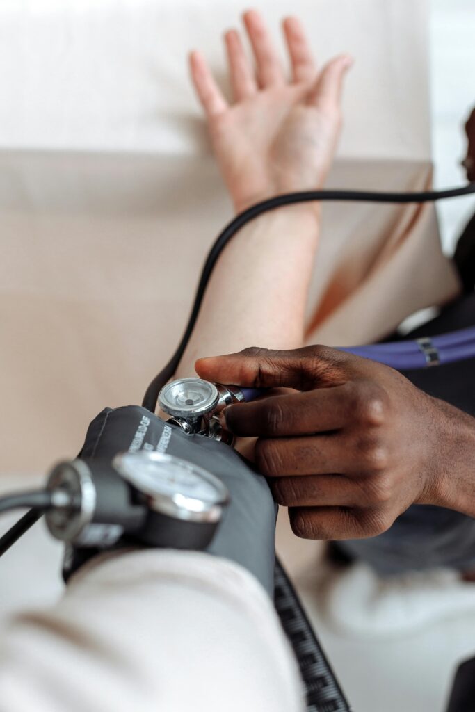 Doctor checking a patient’s blood pressure during a routine medical exam