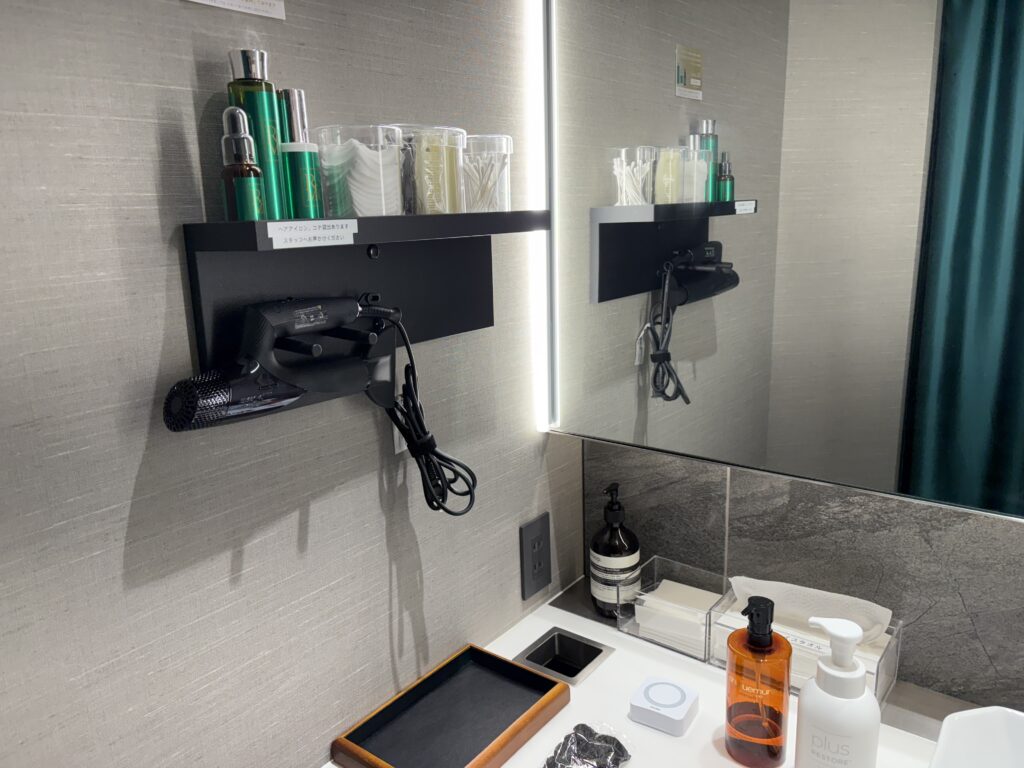 Clean and modern clinic vanity area with skincare products, mirror lighting, and beauty tools prepared for treatment.