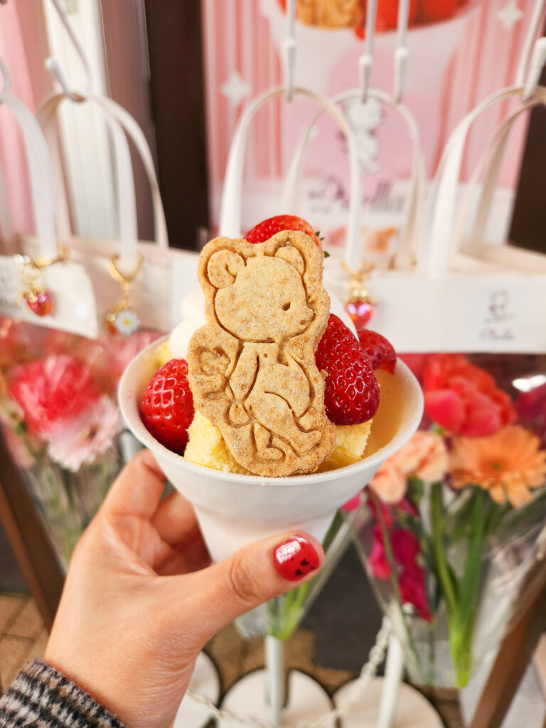 Strawberry shortcake topped with fresh strawberries and a bear-shaped cookie at the Yokohama Strawberry Festival.