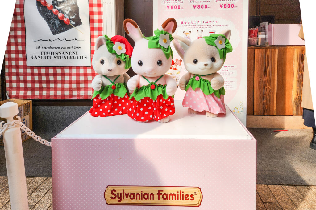 Sylvanian Families characters dressed in strawberry-themed outfits at the Yokohama Strawberry Festival.