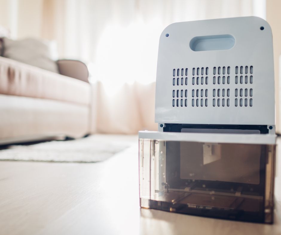 Small dehumidifier placed inside a living room to reduce humidity during rainy season.