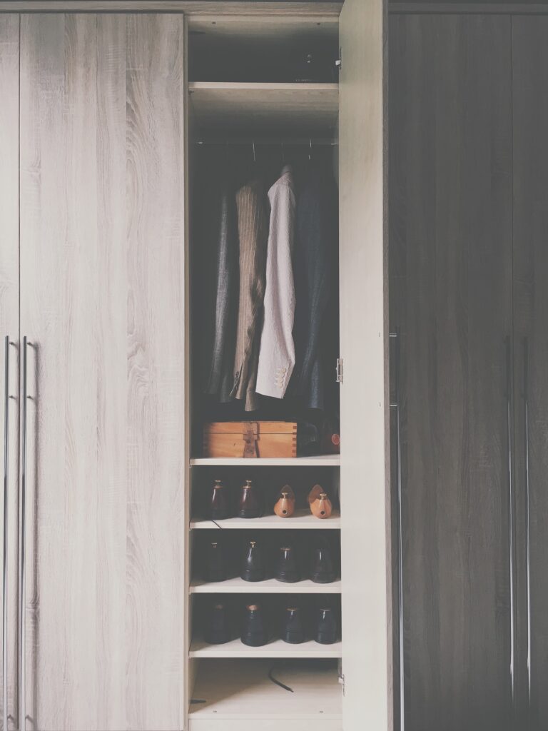 Two woven storage baskets placed on a wooden floor for organizing household items.