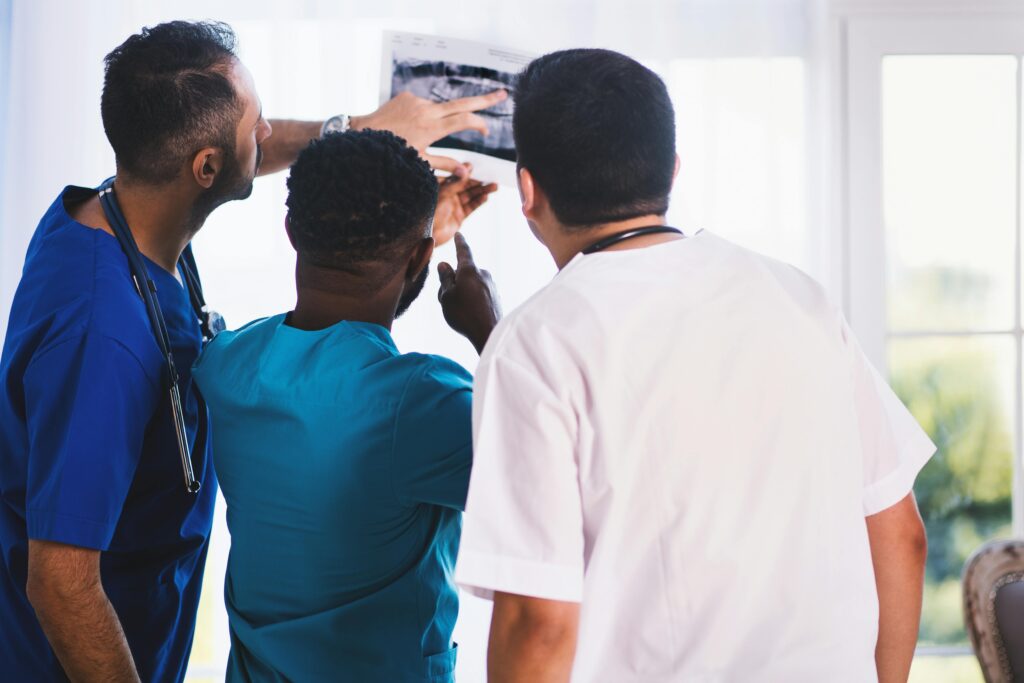 Medical professionals reviewing an X-ray scan together in a hospital setting