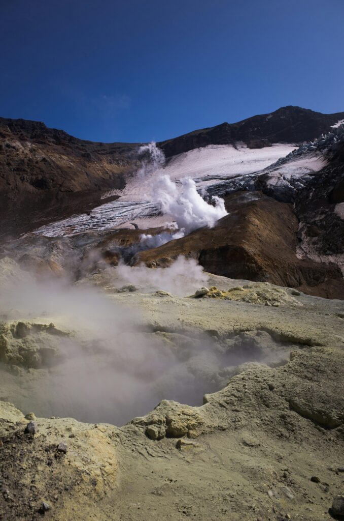Steam rising from an active volcanic landscape, representing volcanic activity and ashfall risks near Tokyo.