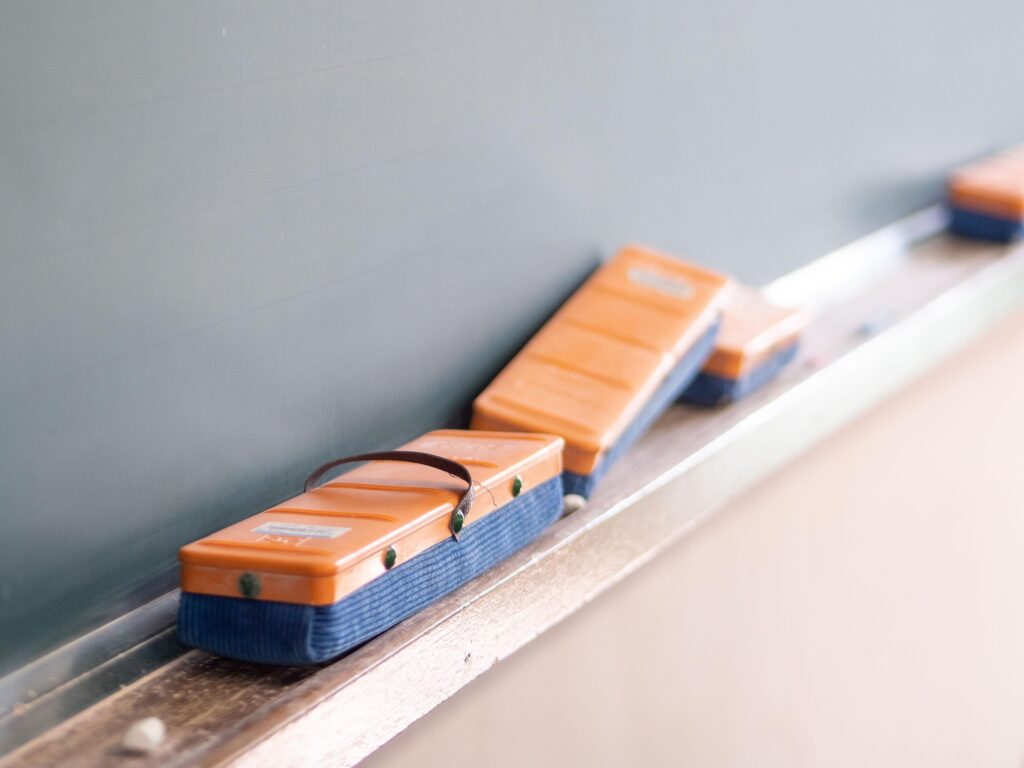 Japanese classroom with chalkboard erasers neatly lined up on the chalkboard tray.