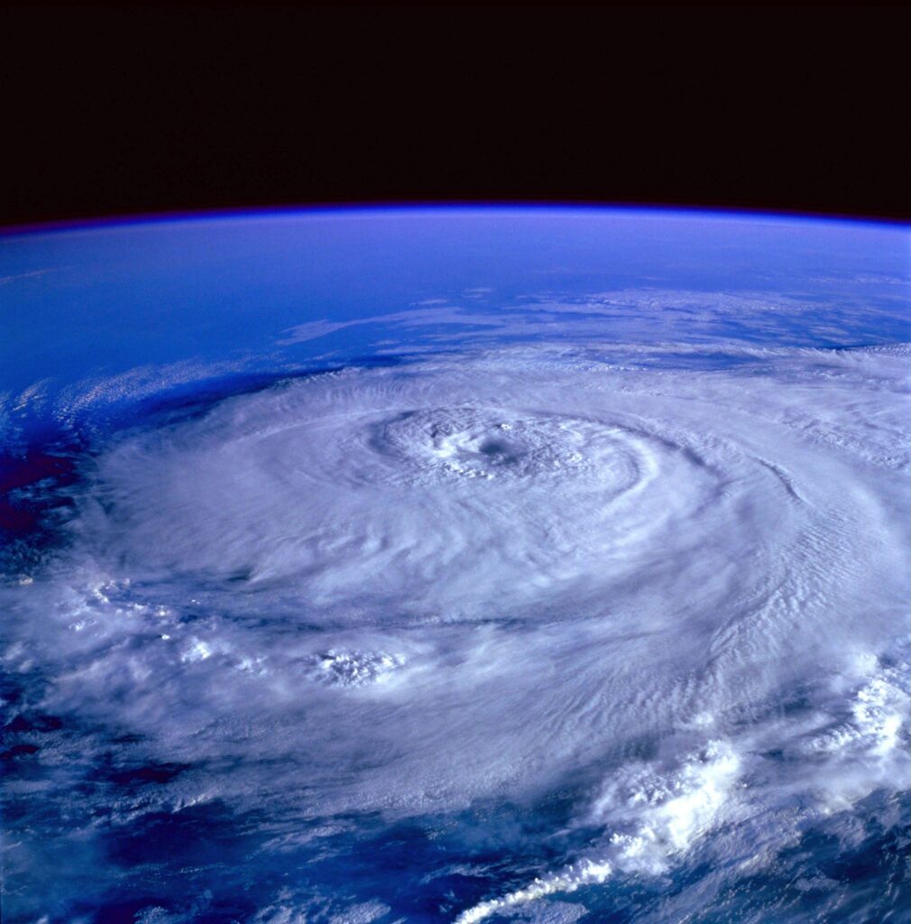 A massive typhoon swirling over the ocean, viewed from space with the storm’s eye visible.