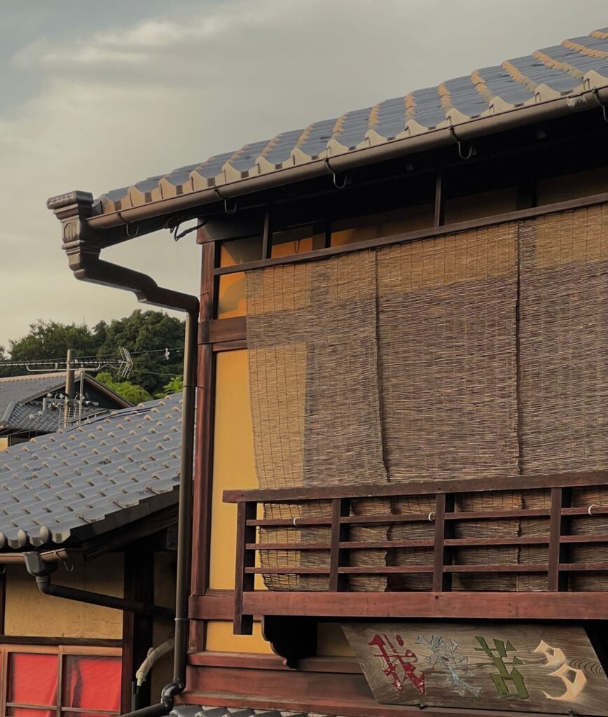 Traditional Japanese home fitted with bamboo sunshades on the windows to block heat and reduce indoor temperatures.