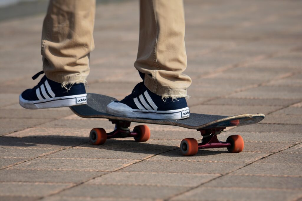 Person riding a skateboard, representing the skateboarding culture and urban lifestyle commonly associated with American youth culture.