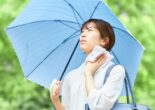 Woman staying cool under a parasol during Japan's hot and humid summer