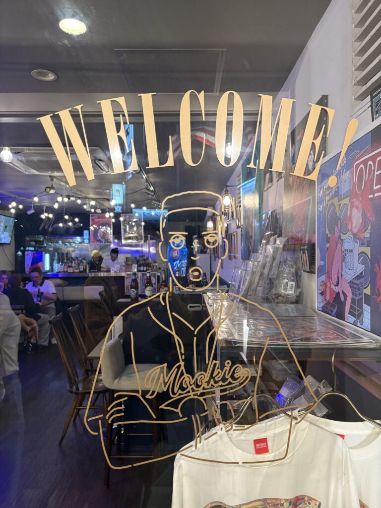Front entrance of Mookie in Osaka, welcoming guests into an American-style diner filled with music, comfort food, and a vibrant atmosphere.