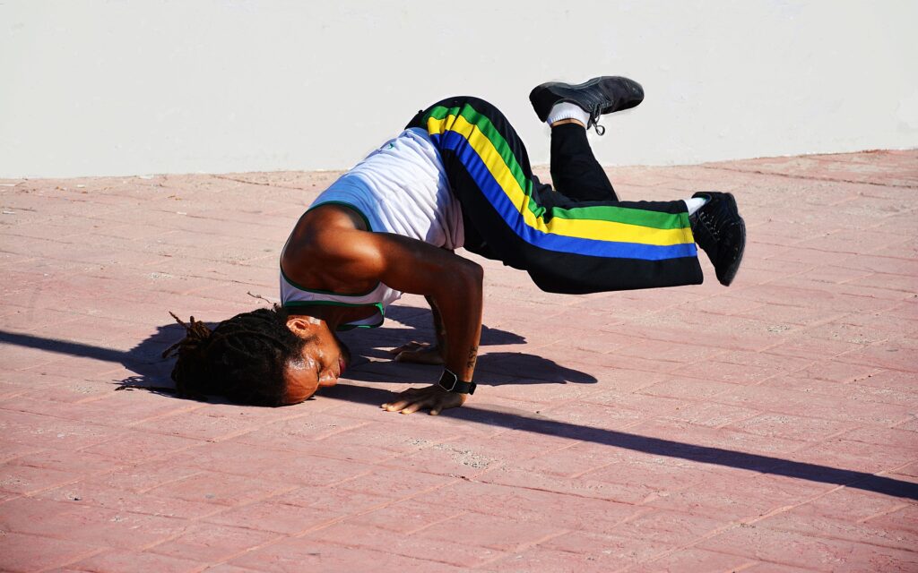Breakdancer performing on an outdoor pavement, showcasing the energy and creativity of hip-hop and American street dance culture.
