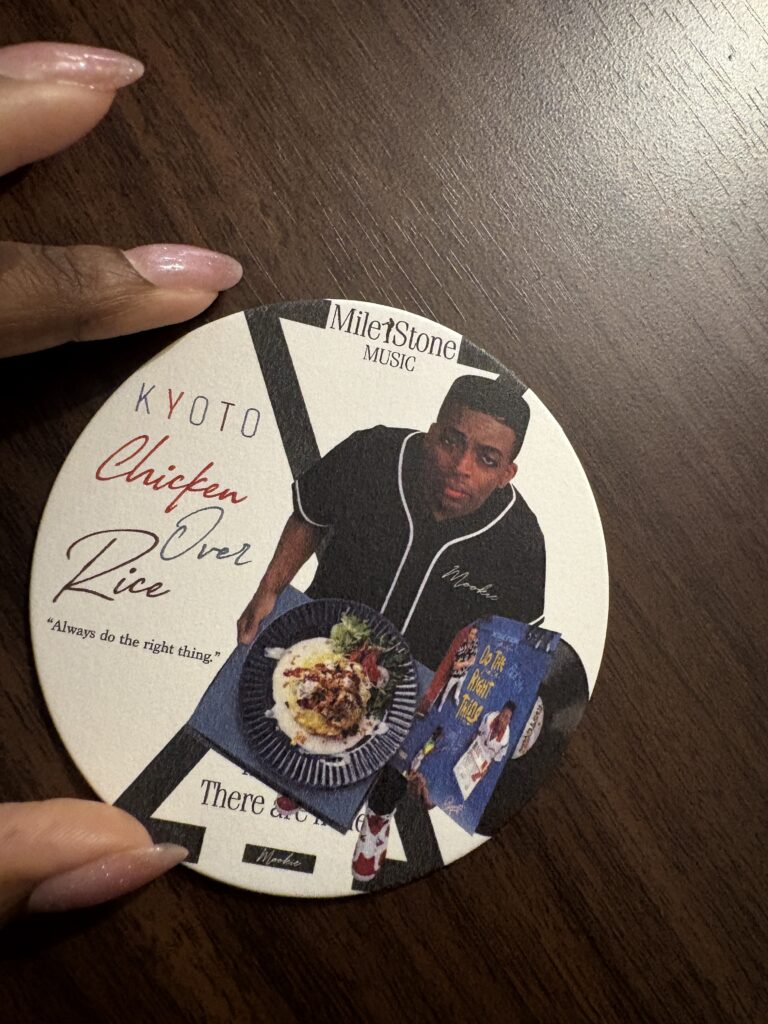Mookie restaurant coaster featuring music-inspired artwork, reflecting the diner's blend of American comfort food, hip-hop culture, and creative atmosphere.