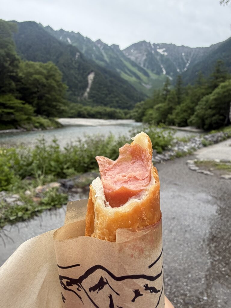 A burrito-style snack enjoyed beside the Azusa River with breathtaking mountain views in Kamikochi, Nagano