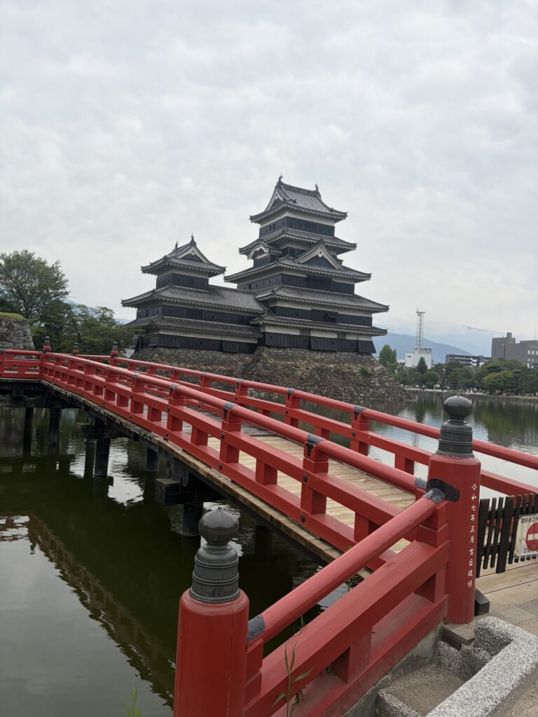 Matsumoto Castle viewed from the bright red bridge across the moat in Nagano, Japan