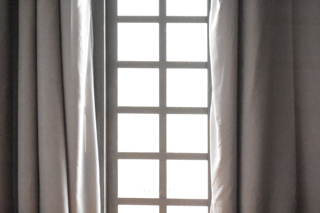Blackout curtains helping keep a bedroom cool during hot summer weather.