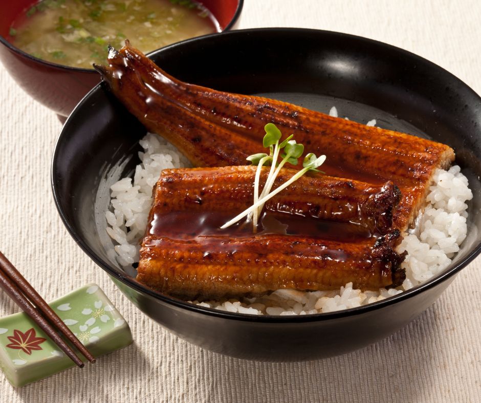 Unadon bowl topped with glazed grilled eel and served with miso soup.
