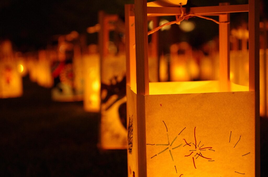 Glowing paper lanterns illuminating a Japanese summer festival.