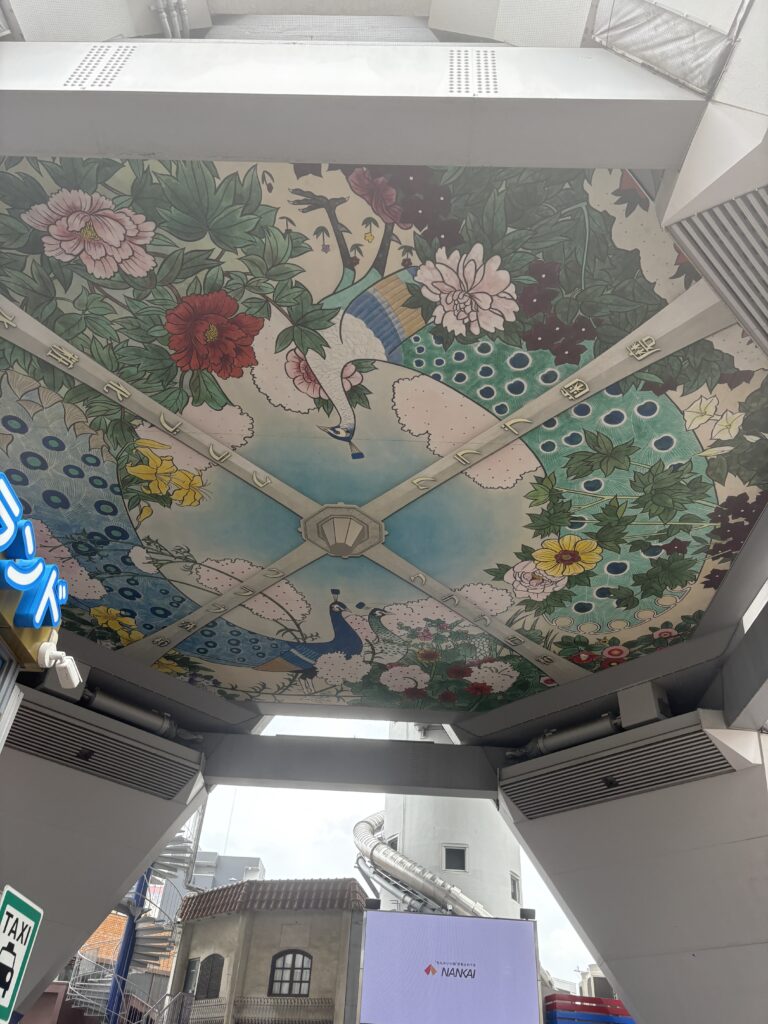 An elaborate ceiling mural decorated with colorful peacocks and flowers spotted while exploring the mystery walk route.